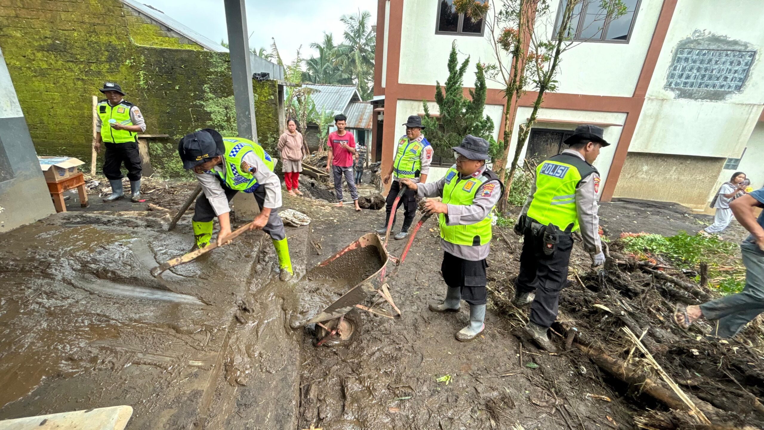 Personel Siaga Bhayangkara membantu membersihkan rumah-rumah warga terdampak banjir bandang, di Desa Sangkanayu, Kecamatan Mrebet Kabupaten Purbalingga.